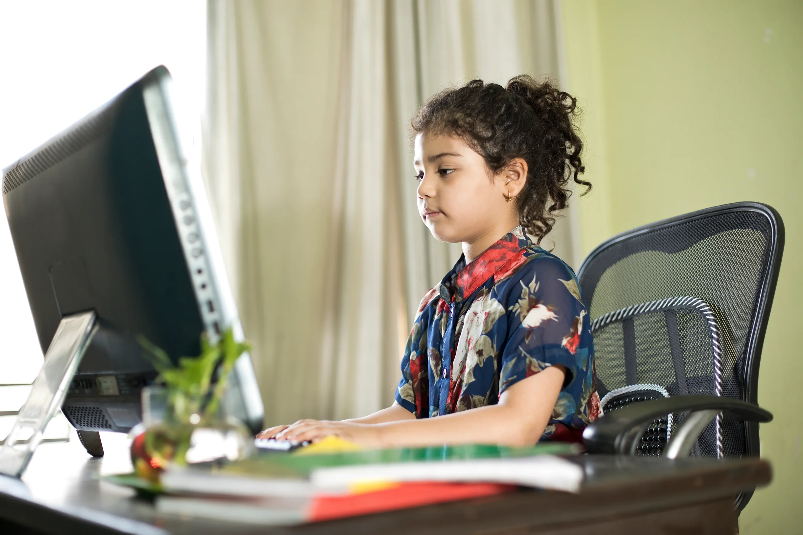 The girl is studing at home on computer